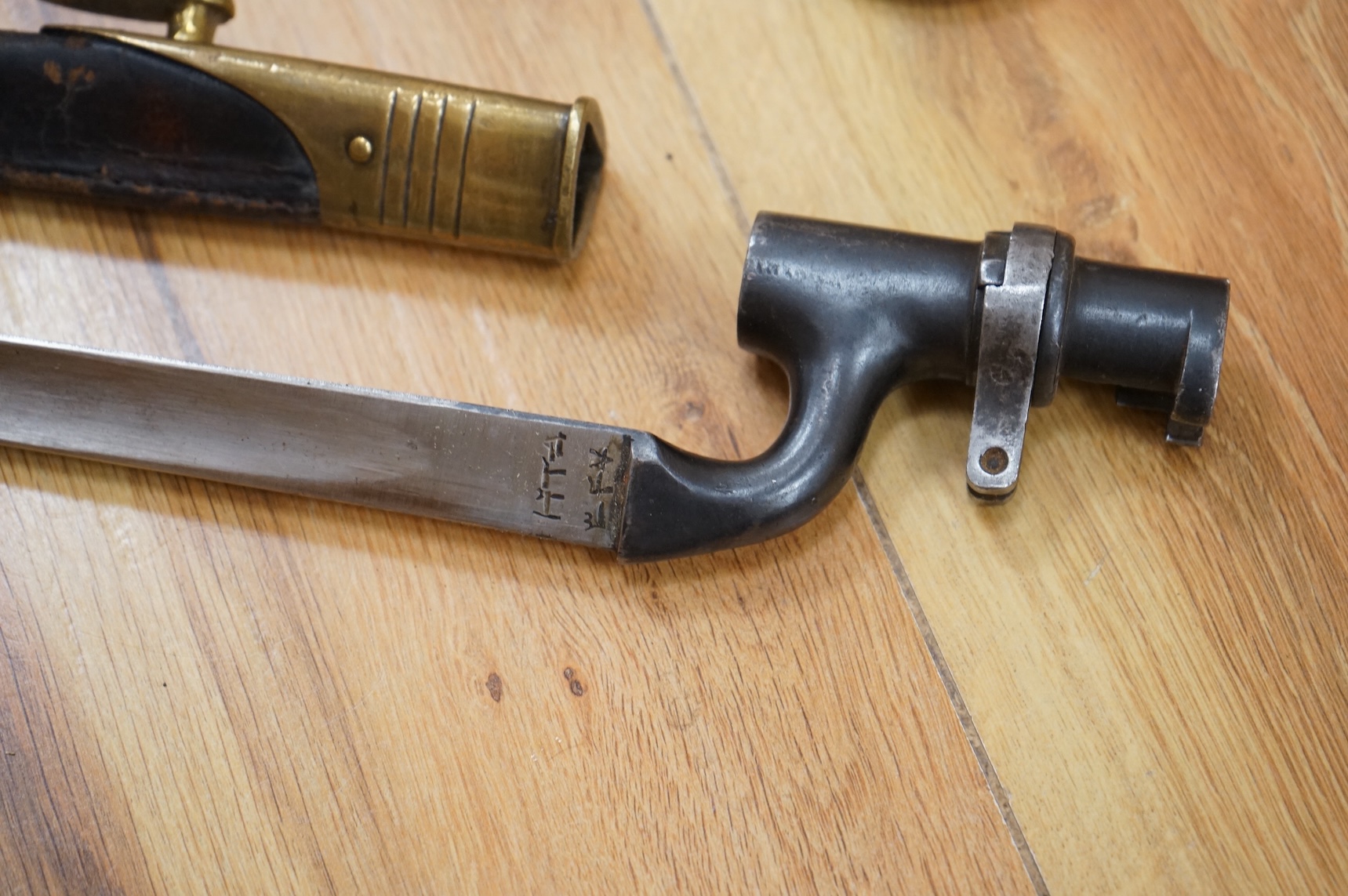 Three bayonets; a gras bayonet, a Lebel bayonet and an Indian Enfield style triangular socket bayonet, all in the original scabbards
